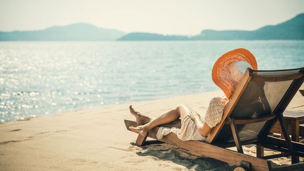 Woman in sun lounge on the beach