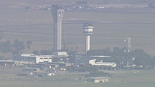 Flights have been suspended at Melbourne Airport after a fire alarm sounded in a control tower.