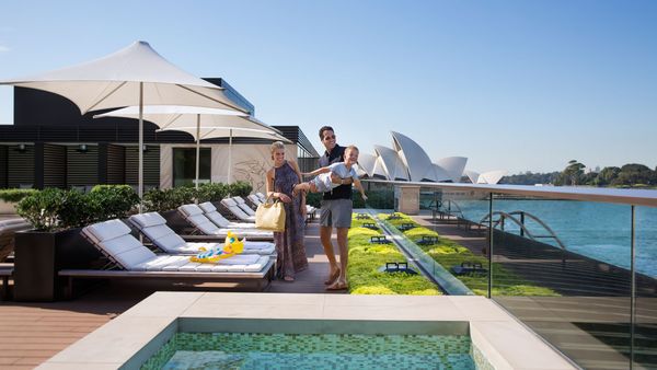 Family on sunbeds at the Park Hyatt Sydney rooftop