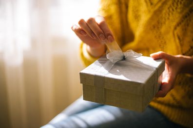 Woman opening birthday present