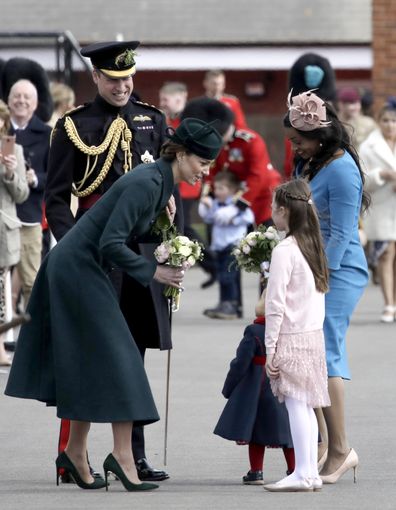 Catherine, Duchess of Cambridge speaks with a young guest and 20-month-old Gaia Money, as she attends the 1st Battalion Irish Guards' St. Patrick's Day Parade with Prince William, Duke of Cambridge at Mons Barracks on March 17, 2022 in Aldershot, England 