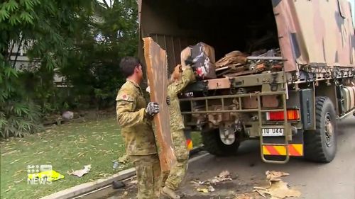 ADF volunteers help in the flood clean up in Reece South in Queensland. 