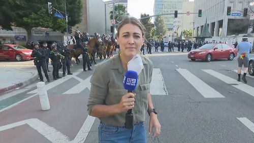 Lauren Tomasi was shot in the leg with a rubber bullet by one of the police officers over her right shoulder.