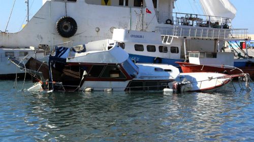 A boat that sunk leaving 14 migrants drown rests in a Turkish port. (AAP)