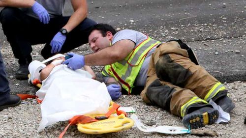 Firefighter comforts young car crash victim by playing 'Happy Feet' on his phone