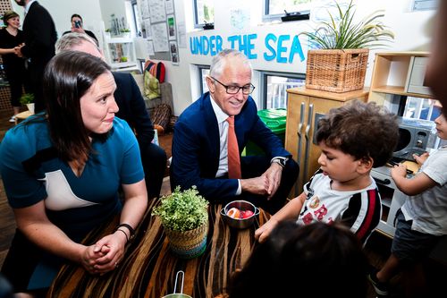 Malcolm Turnbull (centre) speaks with children during a visit to the Teenie Weenies Learning Centre in Panania today. (AAP)