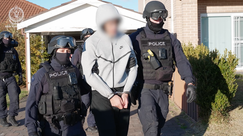 An 18-year-old has been arrested after a brazen stabbing attack that ended with the victim hiding inside a Kmart at a shopping centre in Sydney's west. 