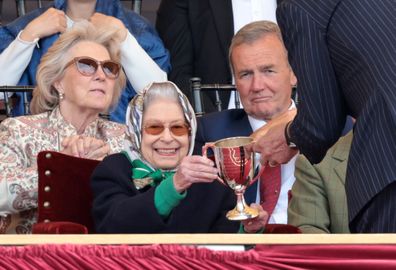 Queen Elizabeth II receives the winners cup at The Royal Windsor Horse Show at Home Park on May 13, 2022 in Windsor, England. 
