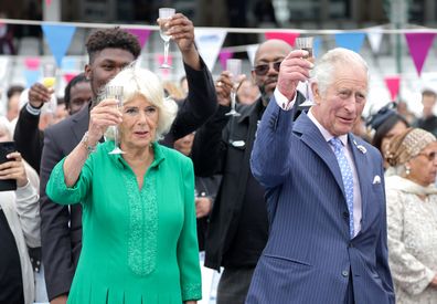 Camilla, Duchess of Cornwall and Prince Charles, Prince Of Wales cheers with glasses of champagne at the Big Jubilee Lunch at The Oval on June 5, 2022 in London, England.  