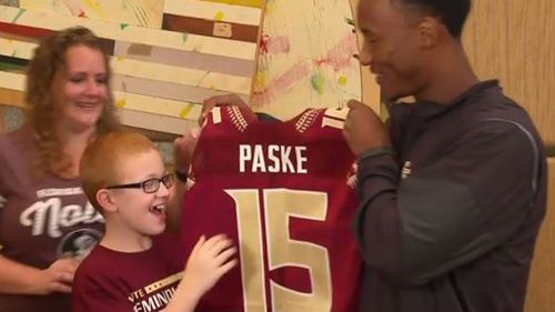 University football player gifts young fan with custom jersey after photo of the pair went viral