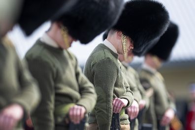 Soldiers from the Welsh Guards bow their heads as they rehearse for Britain's Prince Philip's funeral on the Drill Square at the Army Training Centre Pirbright in Woking, Surrey, England Wednesday April 14, 2021. 