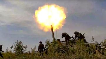 Russian soldiers fire a heavy mortar at Ukrainian targets