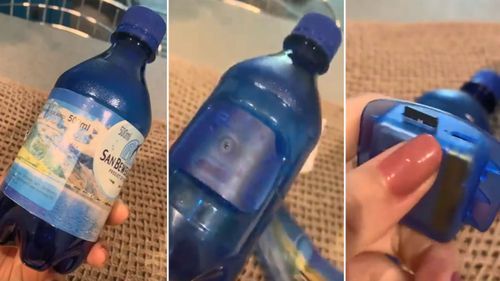 Once the bottle's label was removed the blue camera became visible. 