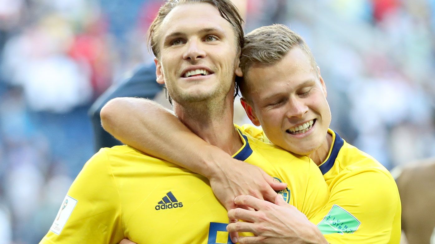 Albin Ekdal and Viktor Claesson celebrate Sweden's victory over Switzerland. (AAP)