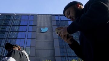 People walk outside Twitter headquarters in San Francisco, Friday, Nov. 4, 2022. 