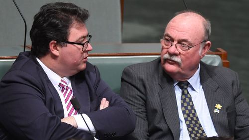 Coalition backbencher George Christensen speaks to Liberal party backbencher Warren Entsch during Question Time (Image: AAP)