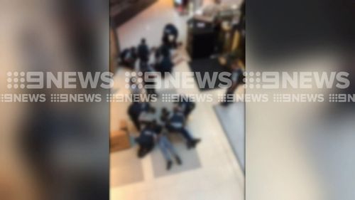 Five men were arrested after carrying replica firearms into Chatswood Westfield this evening.