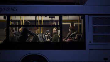 A bus carries internally displaced people from Mariupol and Berdiansk to a refugee center in Zaporizhia, Ukraine, Friday, April 1, 2022. (AP Photo/Felipe Dana)