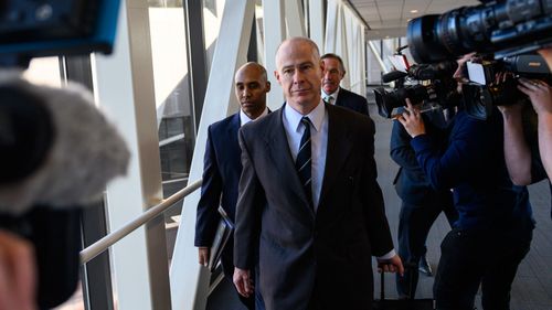 Former Minneapolis police officer Mohamed Noor is surrounded by news media as he exits the Hennepin County Government Centre during the trial.