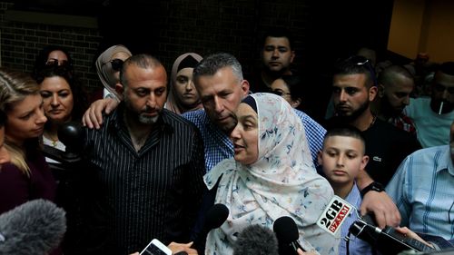 Mahmoud Hrouk's mother Maha Dunia (centre) speaks to the media outside the NSW Supreme Court. (AAP)