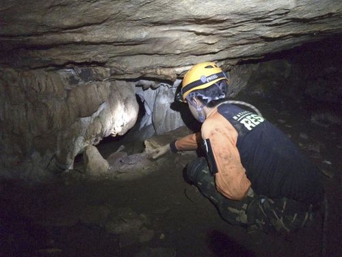 Navy SEAL rescuers who have reached the boys are trying to teach them how to dive underwater to escape the cave, including wearing diving masks and controlling their breathing. Picture: AP.