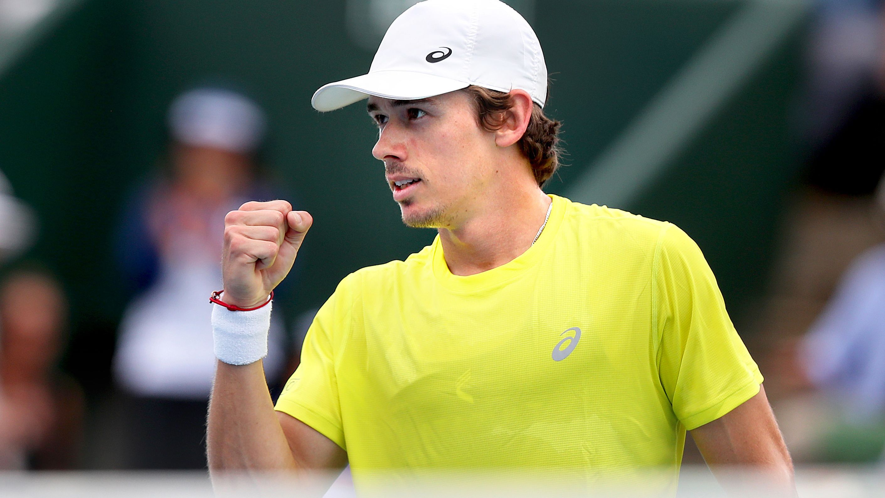 Alex de Minaur of Australia celebrates after winning the first set.