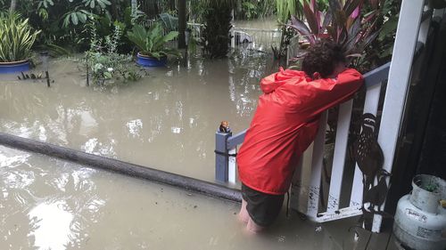 Amelia Rankin sobs as she returns to her flooded Townsville home.