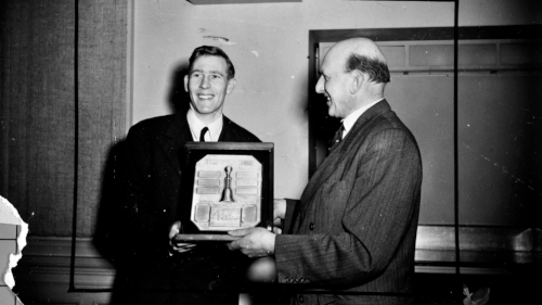 Roger Bannister receives the Helms Trophy for Europe's leading athlete in 1954. (AAP)