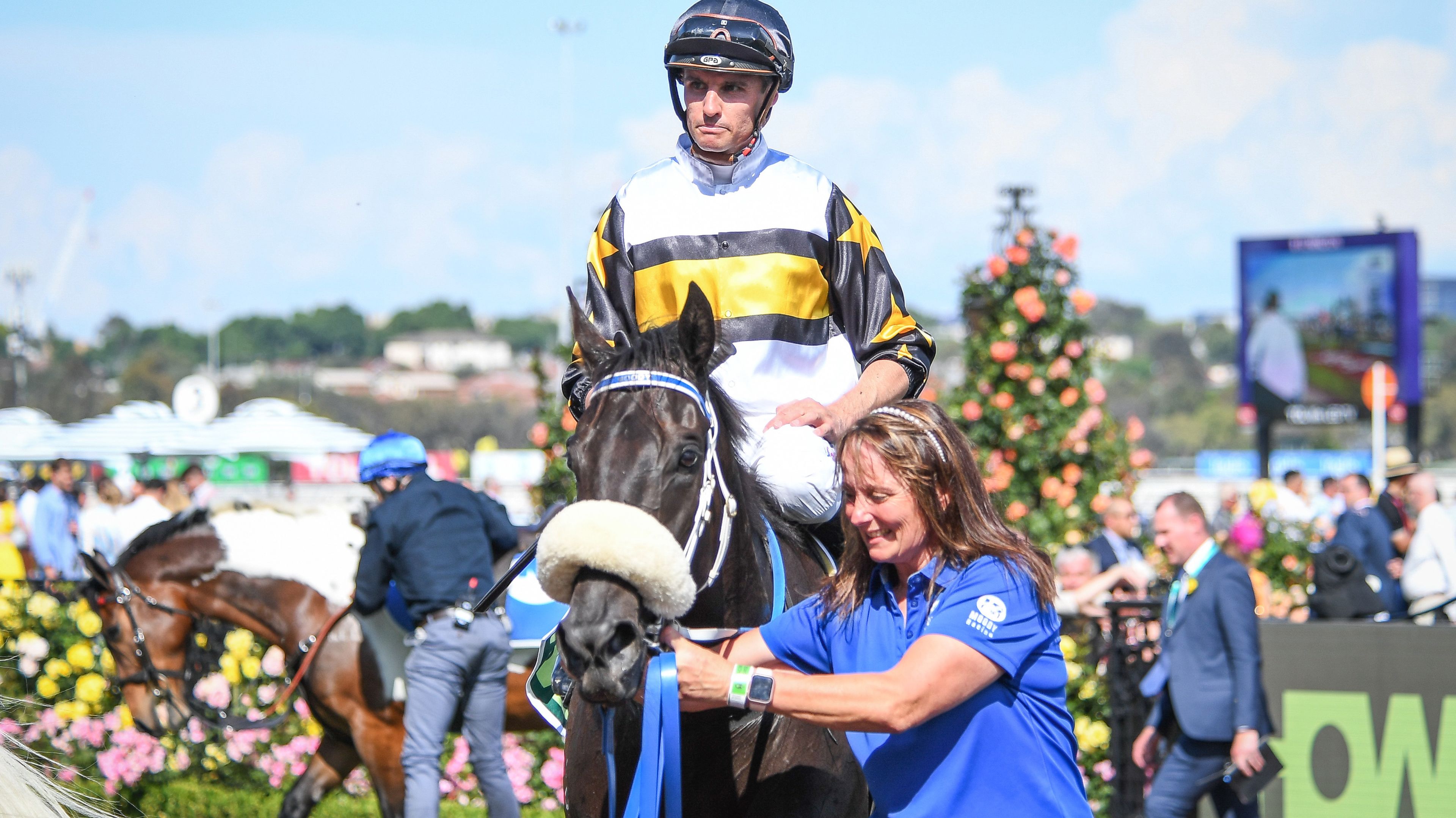 Mark Du Plessis returns to the mounting yard on Magical Lagoon after running in the Melbourne Cup.