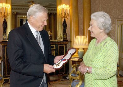 LONDON - JUNE 10: NO UK SATES FOR 28 DAYS Britain's Queen Elizabeth II presents TV naturalist Sir David Attenborough with the Insignia of the Order of Merit, a personal award from the Queen recognising exceptional achievements in the advancement of arts, learning, literature and science at Buckingham Palace on June 10, 2005 in London. (Photo by POOL/Anwar Hussein Collection/Getty Images) *** Local Caption *** Queen Elizabeth II; Sir David Attenborough