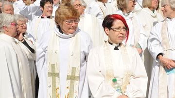 Members of the clergy wait for the start of a service to mark the 20th anniversary of the ordination of women as priests in the Church of England, at St Paul's Cathedral on May 3. (AAP)