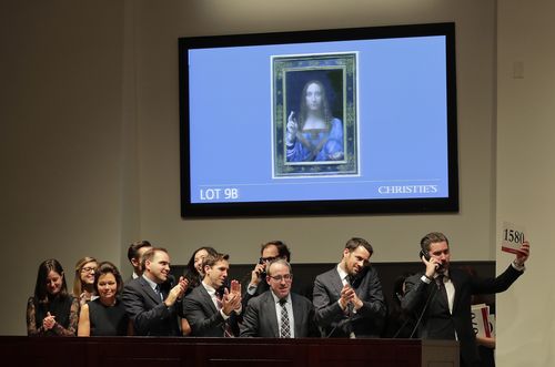 Bidding representatives react after Leonardo da Vinci's "Salvator Mundi" sold for $450 million, including fees, at Christie's.