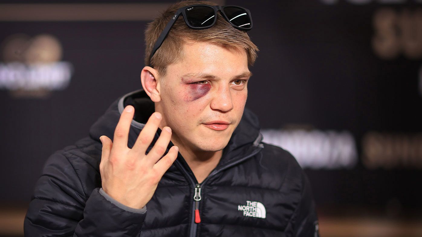 Nikita Tszyu speaks to reporters sporting a bruise under his right eye
