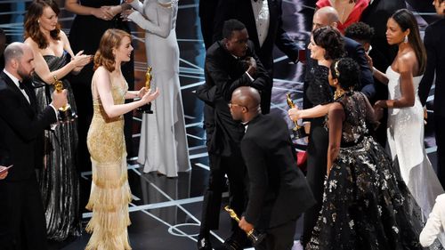 The cast and crew of La La Land welcome those of Moonlight to the stage after the latter was announced as the winner. (AAP)