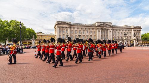 LONDON, UK - 28TH JUNE 2016:  Musical support from the Regimental Band during the Changing of the Guard ceremony at Buckingham Palace in the summer.  The soldiers can be seen wearing scarlet tunics and bearskin caps