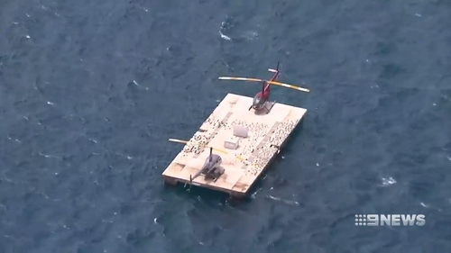 The helicopter floated long enough for the pilot and passengers to be rescued by crews from Hamilton Island. (9NEWS)