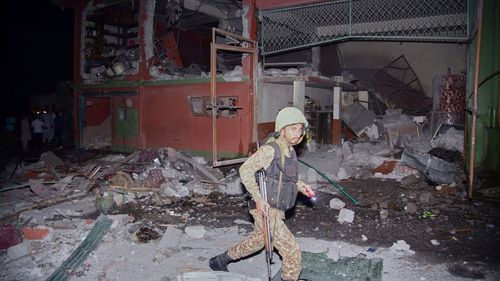 A soldier examines a building damaged by an Indian missile strike near Muzaffarabad in Pakistan-administered Kashmir.