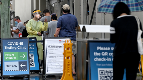 Health care workers dressed in Personal Protection Equipment (PPE) are seen at the Royal Prince Alfred (RPA) Hospital COVID-19 clinic in Sydney, Sunday, January 9, 2022. 