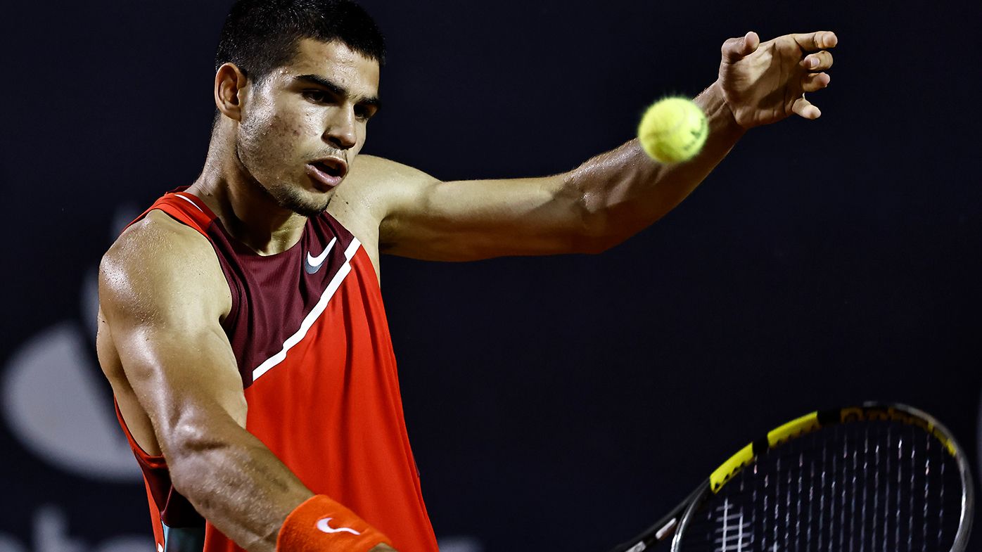 Carlos Alcaraz of Spain returns a shot to Diego Schwartzman of Argentina during the men&#x27;s singles final match of the ATP Rio Open 2022.