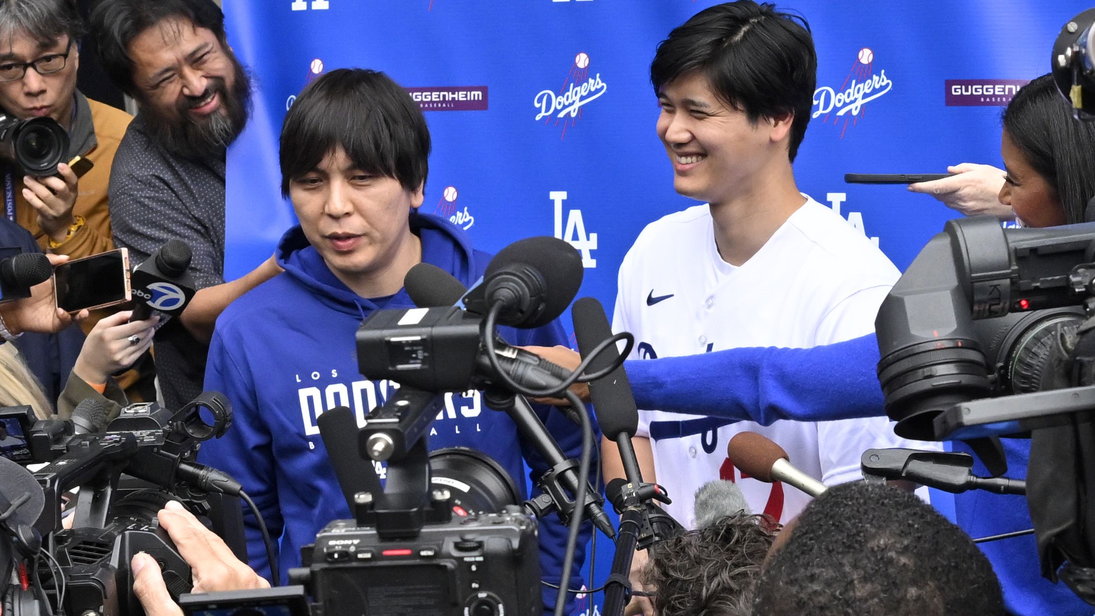 Shohei Ohtani, right, of the Los Angeles Dodgers speaks to the media with the help of his interpreter Ippei Mizuhara during DodgerFest a celebration of the upcoming season with live entertainment, behind-the-scenes experiences, food, drinks and meeting the newest Dodgers at Dodger Stadium in Los Angeles on Saturday, February 3, 2024. (Photo by Keith Birmingham/MediaNews Group/Pasadena Star-News via Getty Images)