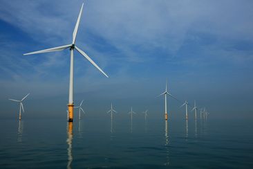 LIVERPOOL, UNITED KINGDOM - MAY 12:  Turbines of the new Burbo Bank off shore wind farm stand in a calm sea in the mouth of the River Mersey on May 12, 2008 in Liverpool, England. The Burbo Bank Offshore Wind Farm comprises 25 wind turbines and is situated on the Burbo Flats in Liverpool Bay at the entrance to the River Mersey, approximately 6.4km (4.0 miles) from the Sefton coastline and 7.2km (4.5 miles) from North Wirral. The wind farm is capable of generating up to 90MW (megawatts) of clean,