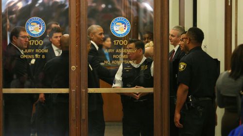 Former President Barack Obama arrives for jury duty in the Daley Center. Obama is in line to be paid the same $17.20 a day that others receive for reporting for jury duty. (Nancy Stone/Chicago Tribune via AP)