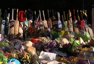 Dozens of cricket bats and floral tributes inside Adeladie Oval.