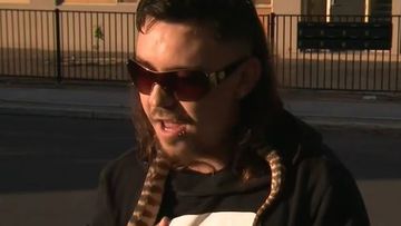 Josh Ellul-Kerr stood with a snake around his neck as he spoke to 9News about his friend who was shot in Adelaide.