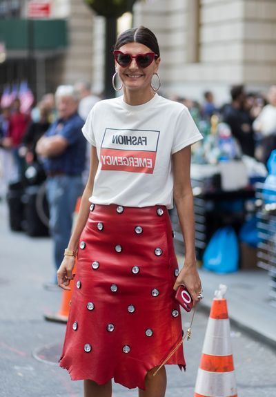 Style maven Giovanna Battaglia knows the power of red. Here she wears a bold red skirt, a slogan T-shirt with a hint of the shade and speaking of, red sunglasses.