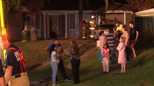 Neighbours outside the home last night. (9NEWS)