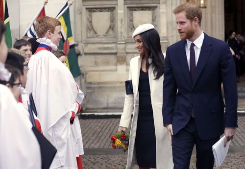 Meghan chats to the choirboys as she leaves the service. Picture: PA/AAP