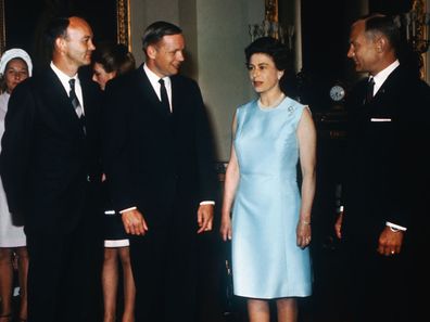 Michael Collins, Neil Armstrong, and Buzz Aldrin with Queen Elizabeth at Buckingham Palace.