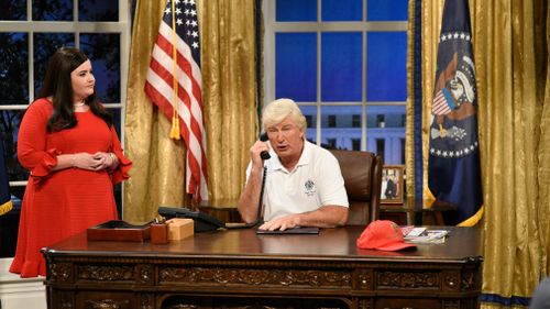 Aidy Bryant portrays White House press secretary Sarah Huckabee Sanders, while Alec Baldwin plays President Donald Trump during the cold open for "Saturday Night Live". (AP)