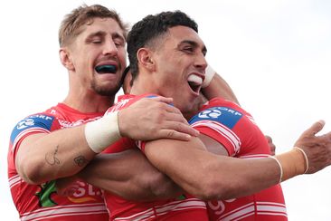 Zac Lomax and Tyrell Sloan celebrate a try with Dragons teammate Mat Feagai against the Raiders in 2023.